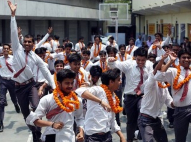 Students celebrating with orange garlands
